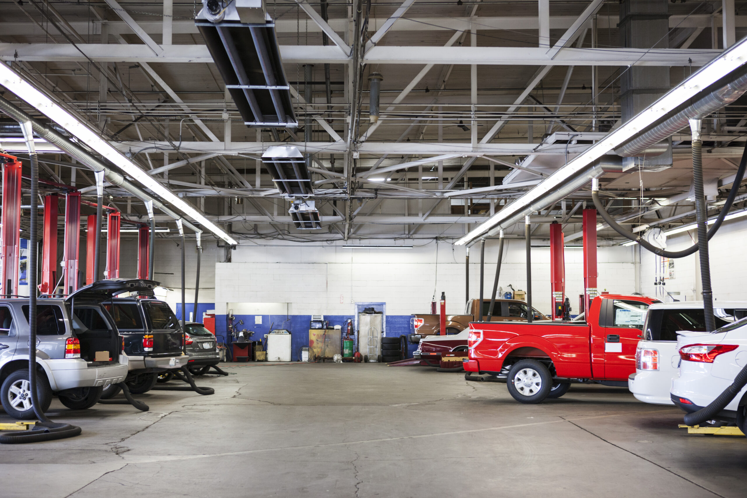 Cars and trucks inside of an auto shop